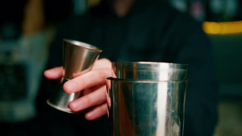 professioneller Barkeeper kreiert ein Cocktailgetränk Erfahrener Barkeeper gießt ein alkoholisches Getränk ein