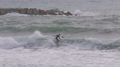 Male Surfer Riding a Wave