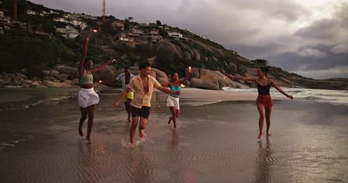Running, sparklers and friends on beach at sunset for holiday, vacation and weekend together