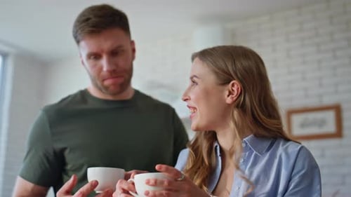 Couple Working at Home Share Coffee and Conversation