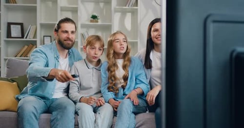 Happy Family Relaxing on the Sofa Together