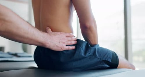 Man Receiving Lower Back Massage in Hospital
