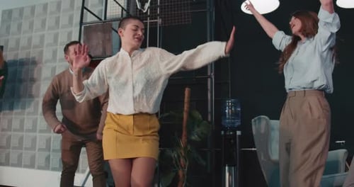 Happy Young Short Haired Businesswoman Celebrating Career Success Dancing at Fun Office Party with