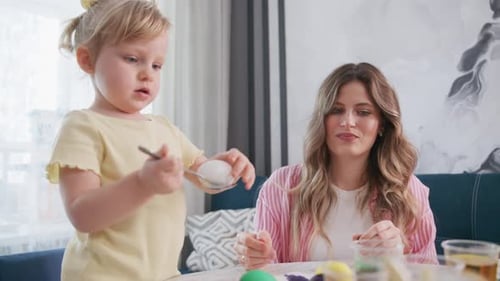 Child and Adult Create Easter Crafts Side By Side
