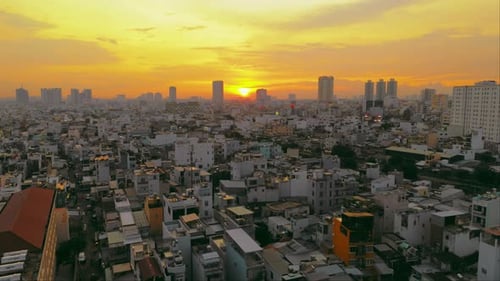 A breathtaking aerial shot captures the beauty of a bustling metropolis as the sun dips below the ho