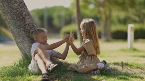 Children Playing Hand Clapping Games Under a Tree