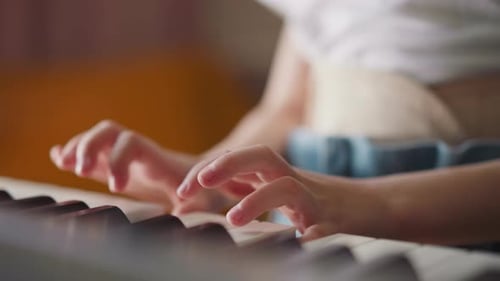 Child's Hands Playing Keyboard Piano