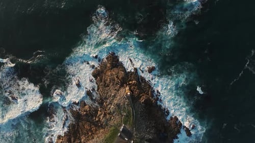 Top-down View Of Waves Breaking Against The Shore In Summer. - aerial shot