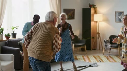 Seniors Dancing Together in Bright Living Room