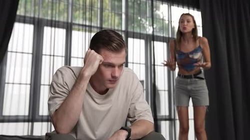 Frustrated Woman Arguing with Upset Man in Bedroom