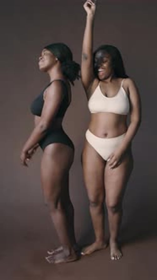 Two Happy Women in Underwear Dancing and Having Fun in Studio