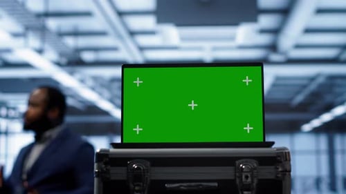 Green Screen Laptop Used By Engineers Monitoring Server Room