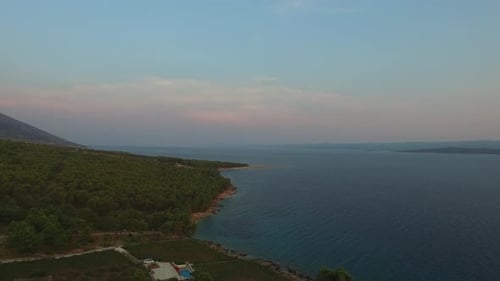 Coastal Croatia at sunset. Wide aerial view with colorful sky and green landscape of Hvar Island. Sm