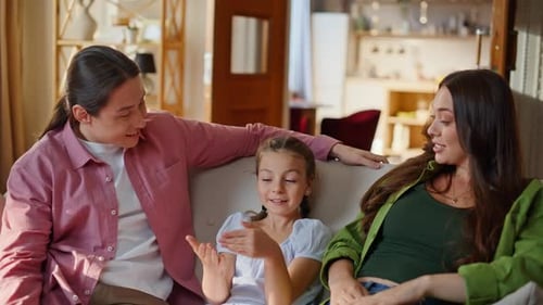 Family Relaxing Together on Sofa in Sunny Home