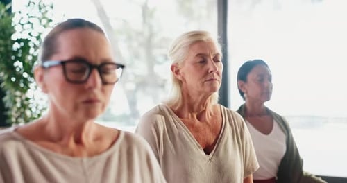 Women Meditating Together Peacefully in Bright Modern Home