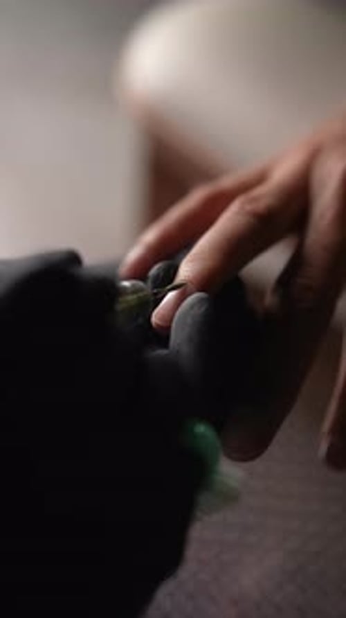 Vertical Cropped Shot of Beautician in Black Gloves Using an Electric Nail Drill Machine to Remove