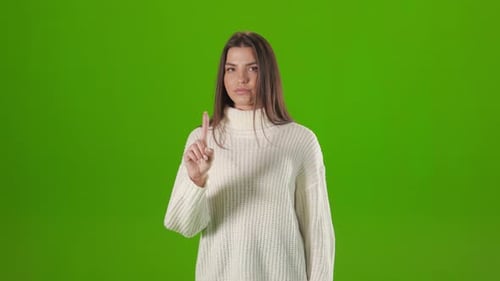 Young Woman Gesturing with Finger for Saying No in Studio