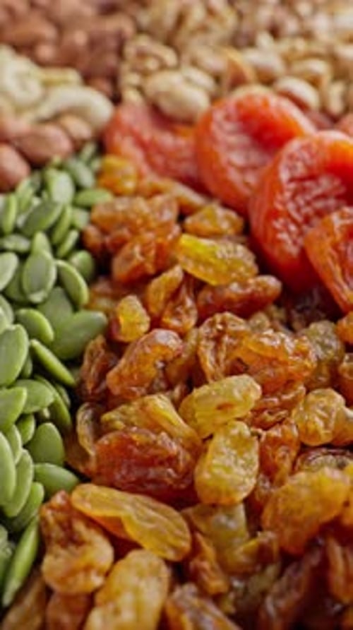 Colorful Assortment of Nuts and Dried Fruits Rotating Healthy Food Concept