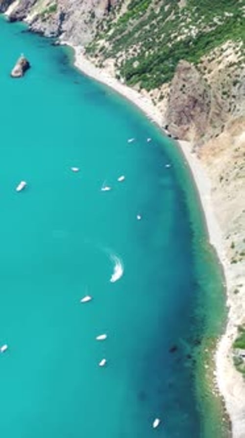 Aerial Vertical View of Seascape with Crystal Clear Azure Sea and Rocky Shores Yachts in a Beautiful