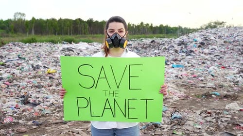Woman in Respirator Holds Save the Planet Sign