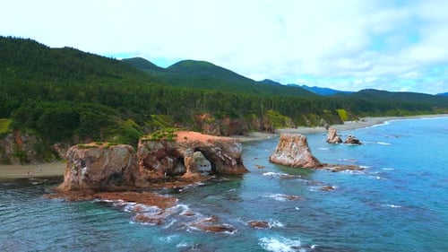 Top view of beautiful coast with rocky arches. Clip. Amazing nature of erosion in sea rocks on coast