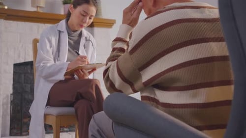 Young Doctor Visits Senior Patient at Home
