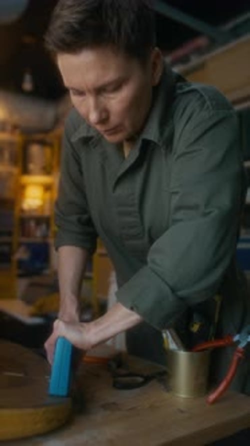 Vertical of Artisan Stapling Back of Chair in Furniture Workshop