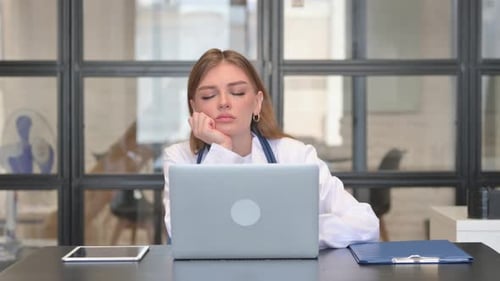 Tired Female Doctor Sleeping in Clinic