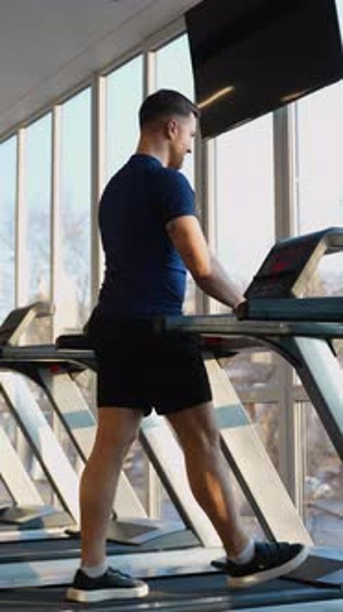 Man Running on Treadmill at Modern Gym