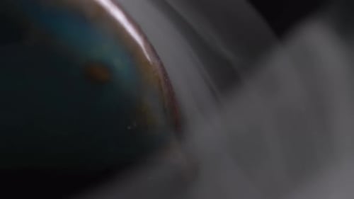 Macro shot of iridescent reflective sphere with fog