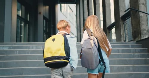 Happy school students outdoor walking and talking to each other. Portrait of cheerful kids