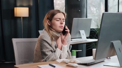 Woman Talking on Phone at Desk, Sick with Cold