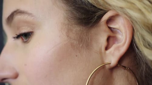 Woman Wearing Gold Hoop Earring, Close Up