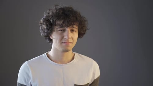 Grieving young man looking at camera.
