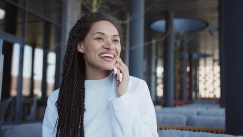 Portrait Happy Smiling Young Woman Sitting Speak on Mobile Phone Relaxing Outdoors on Street Slow