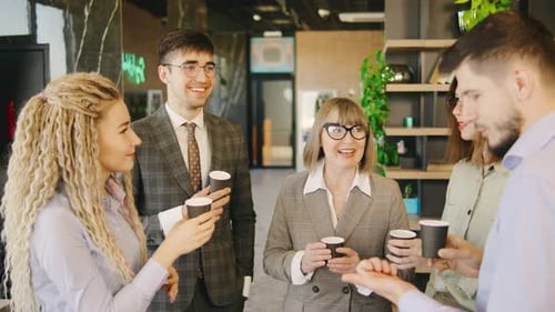 Smiling Colleagues Chatting During Coffee Break