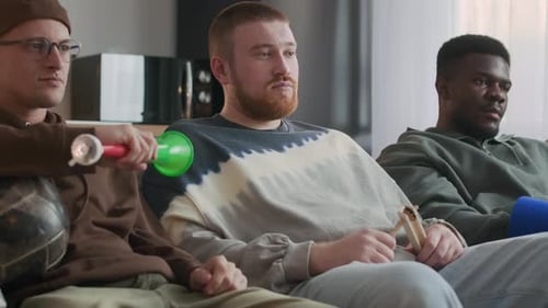 Friends Watching Sports Game at Home, Cheering and Celebrating