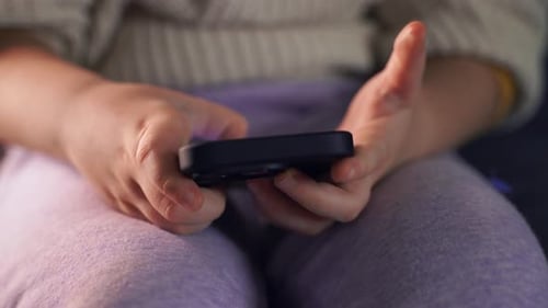Child's Hands Holding Smartphone