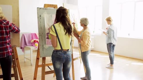 Art School Creativity and People Concept - Group of Students with Easels