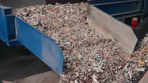 Shredded Rubber Material Moving on Conveyor in Recycling Factory