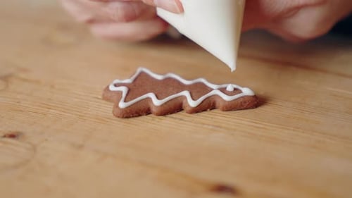 Decorating Gingerbread Cookies for Christmas, Closeup Shot Making handmade festive new year sweets a