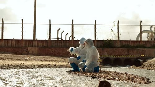 Scientists Taking Water Samples in Protective Suits