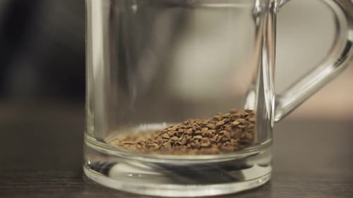 Pouring Water into Instant Coffee Close Up