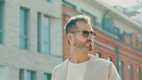 Man Wearing Sunglasses on City Street