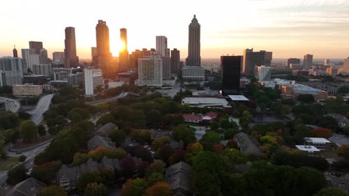 Aerial of Atlanta Georgia skyline at sunset. Beautiful light among skyscrapers. Truck shot.