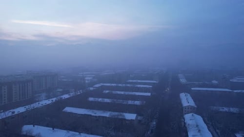Dawn Over the City in Fog and Smog