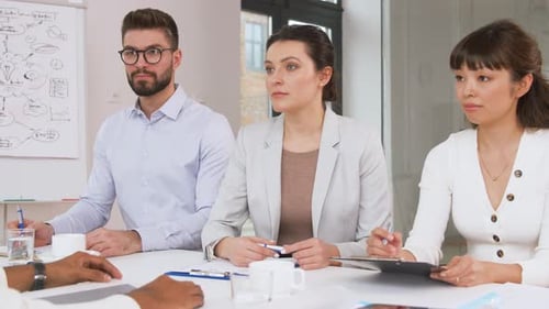 Business Professionals in Meeting Discussing Ideas in Office