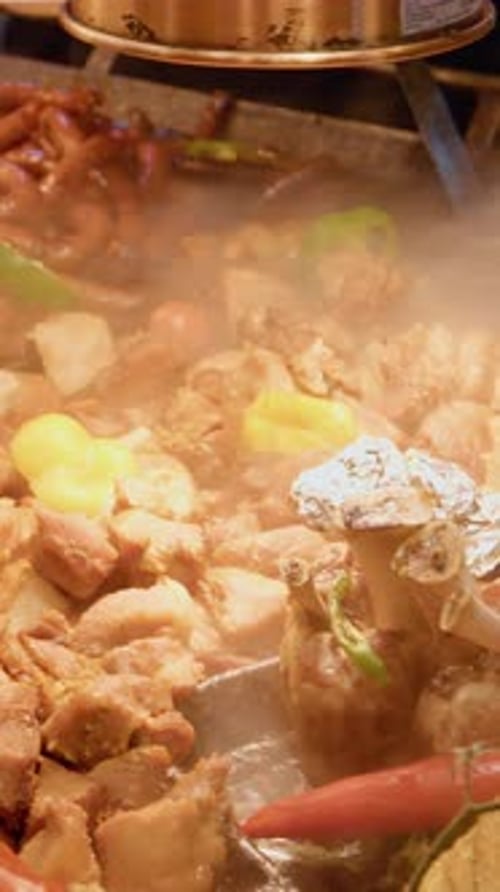 Variety of Meats and Vegetables Cooking on a Grill