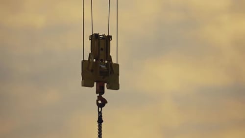 close up of construction crane hanging in the air, hard work lifestyle