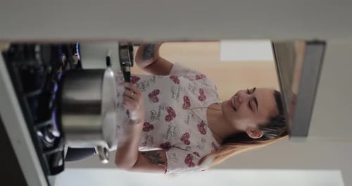Young Woman Cooking in Kitchen